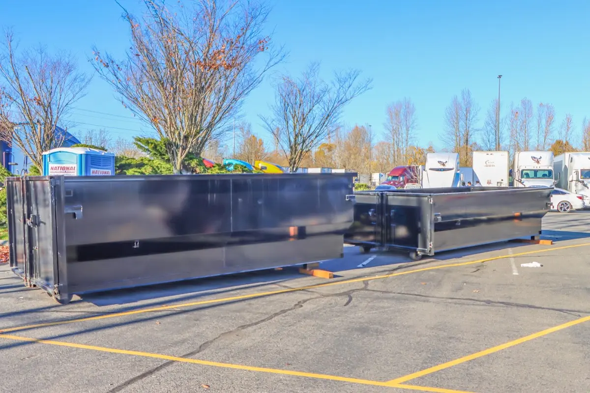 Professional dumpster rental service with roll-off container on residential driveway in Ruston